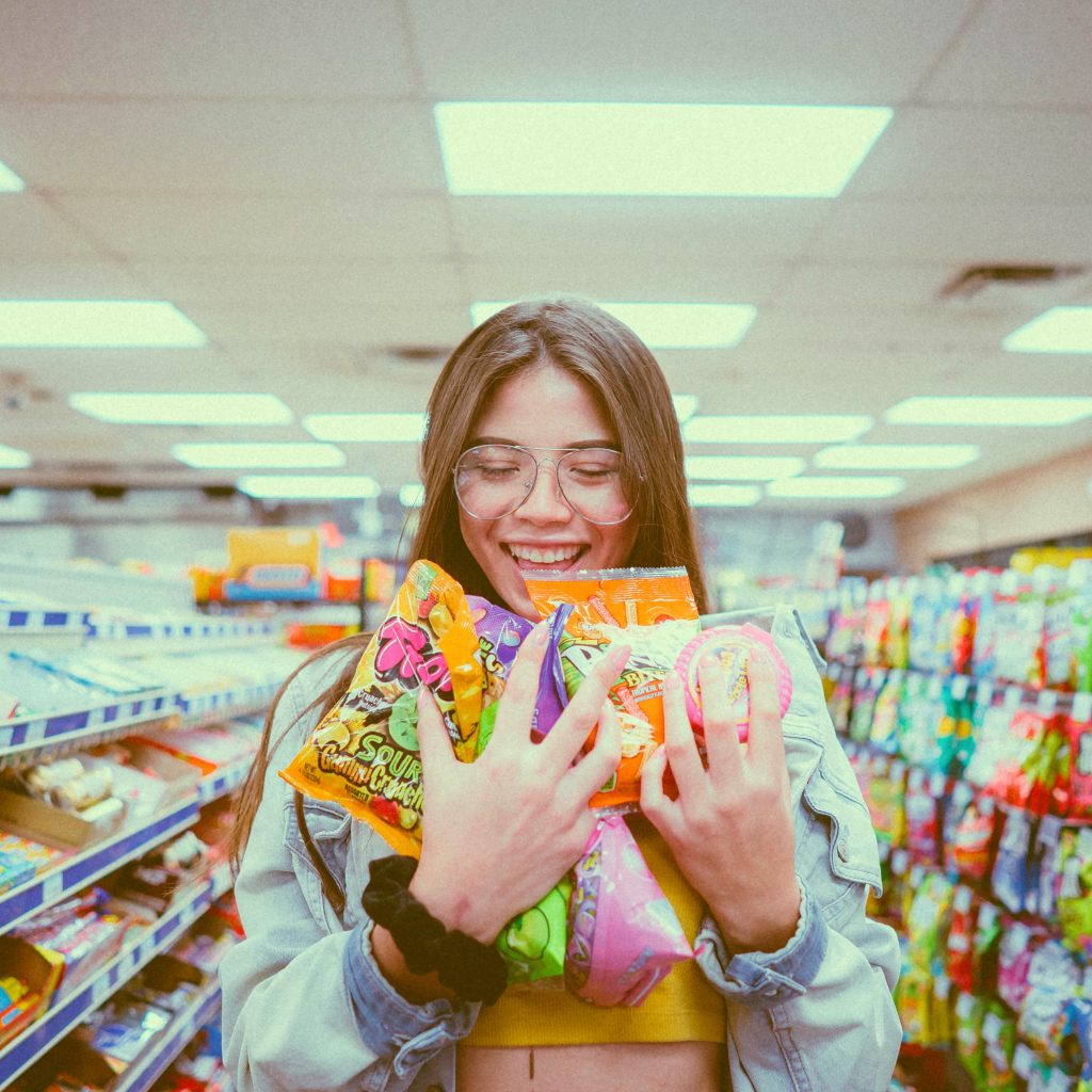 Une jeune femme portant des bonbons dans un supermarché